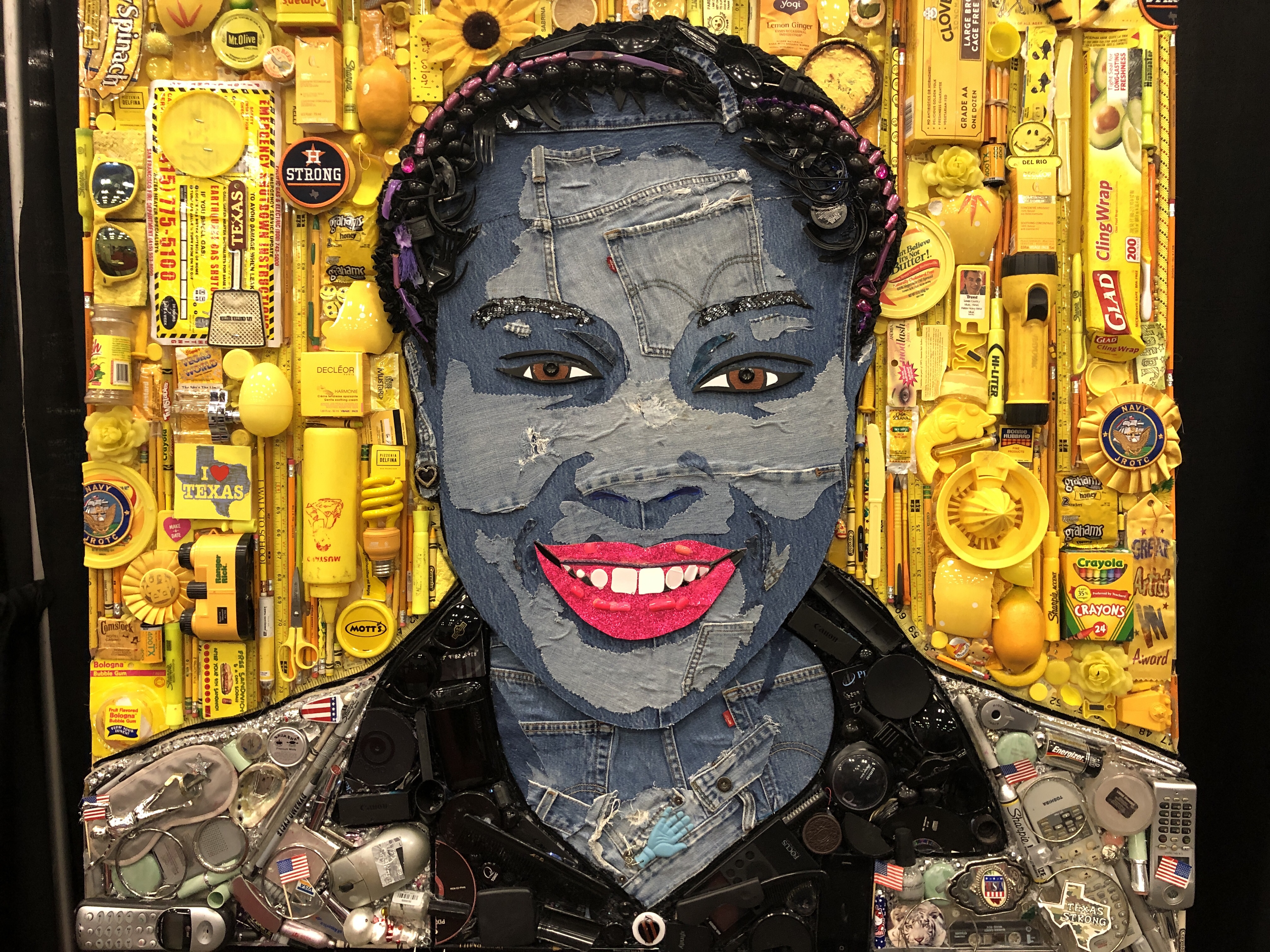A photo of a mosaic of an African-American woman surrounded by yellow objects that represent her background.